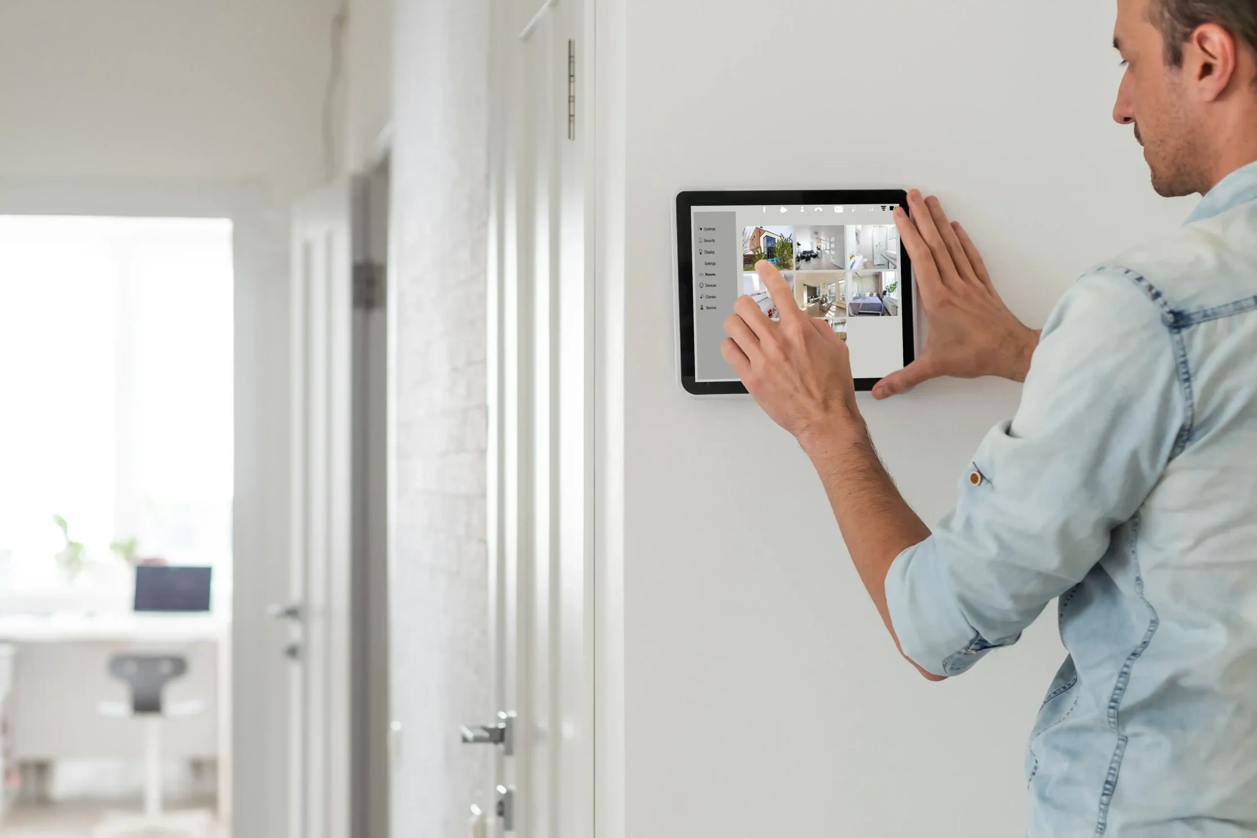 Person interacting with a wall-mounted tablet