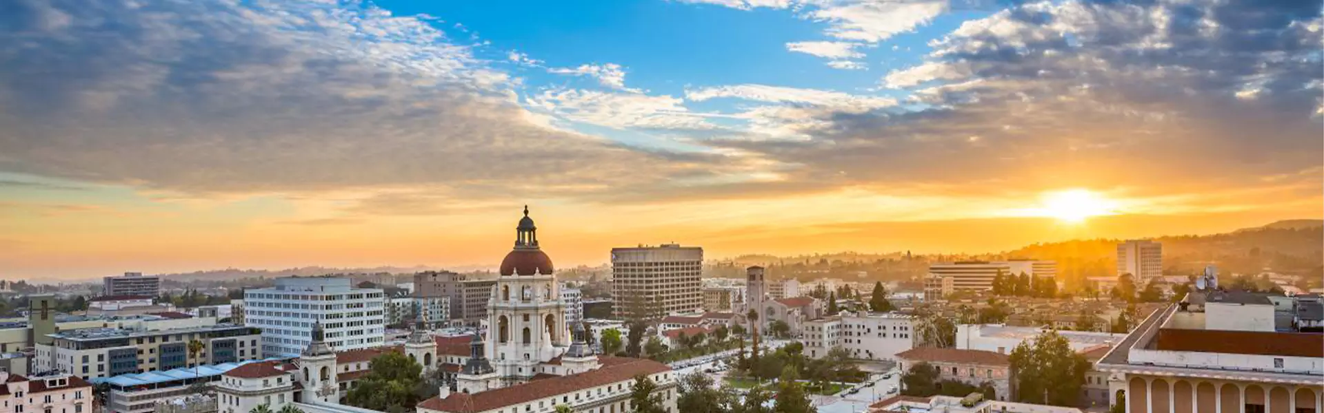 Sunset over a city skyline with buildings.