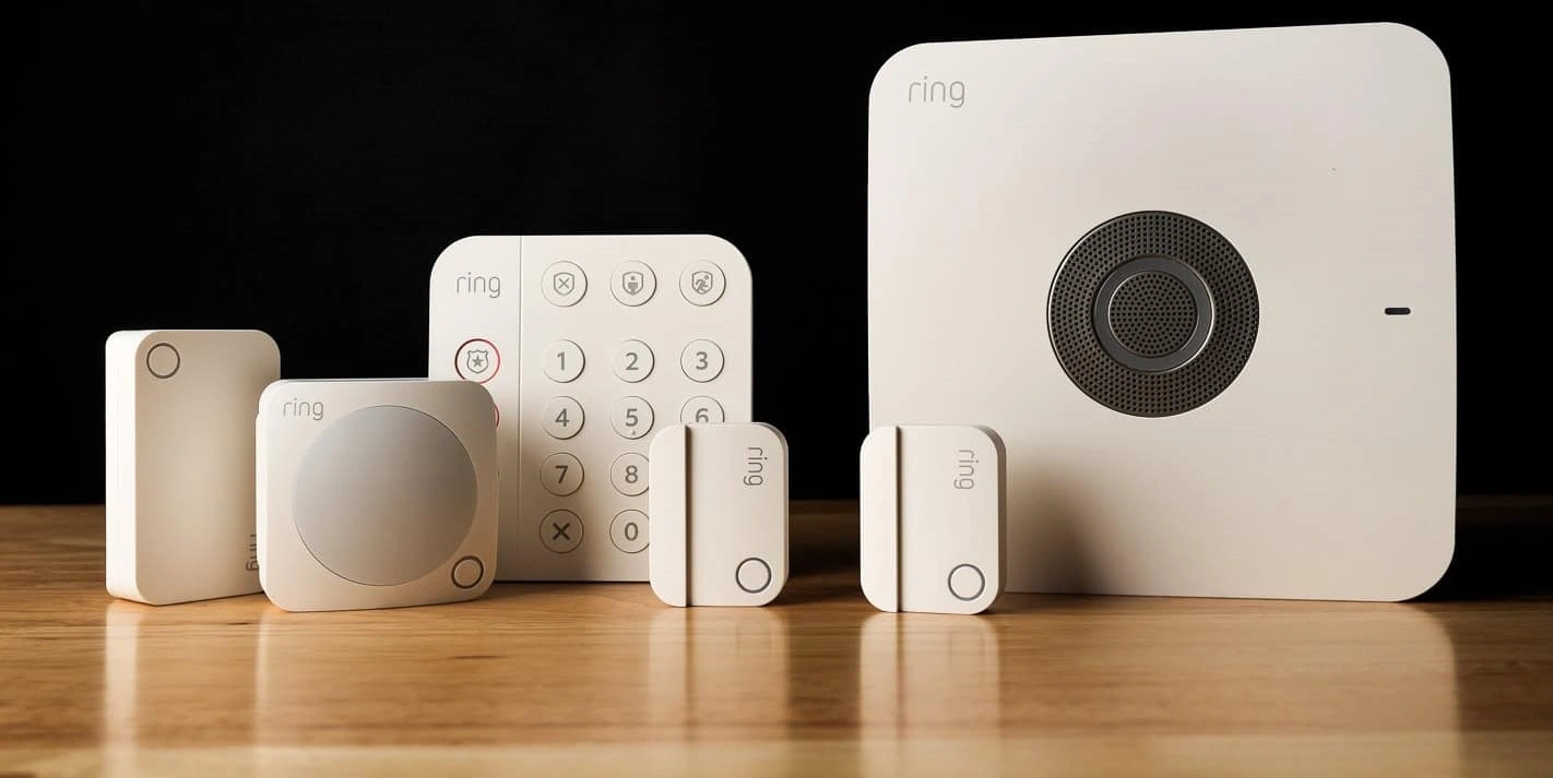Various Ring security devices on a wooden surface.