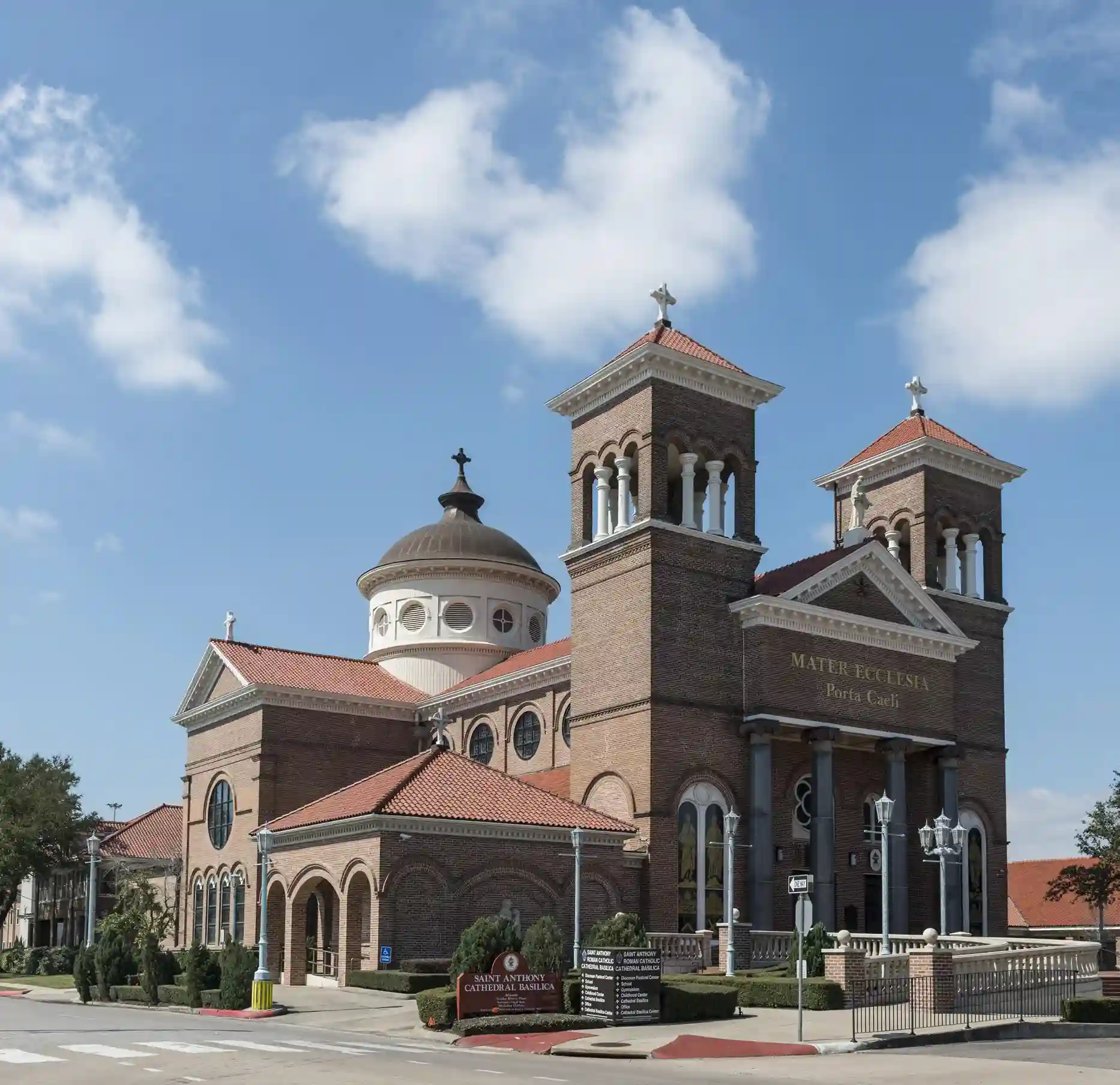 Historic church with towers and red roof.