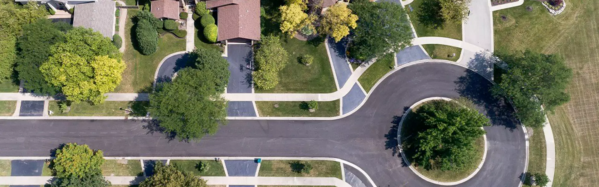 Aerial view of suburban neighborhood with curvy streets.