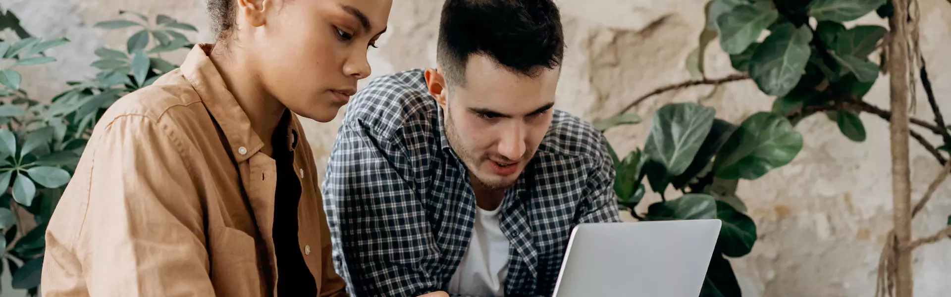 Two people collaborating on a laptop.