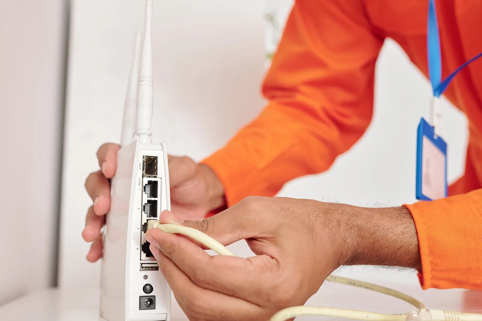 Person connecting cable to a wireless router