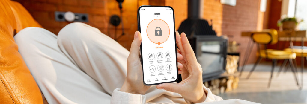 User interacting with home security app on smartphone.