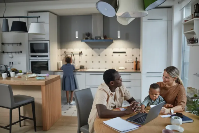 Family interacting in a modern kitchen setting.
