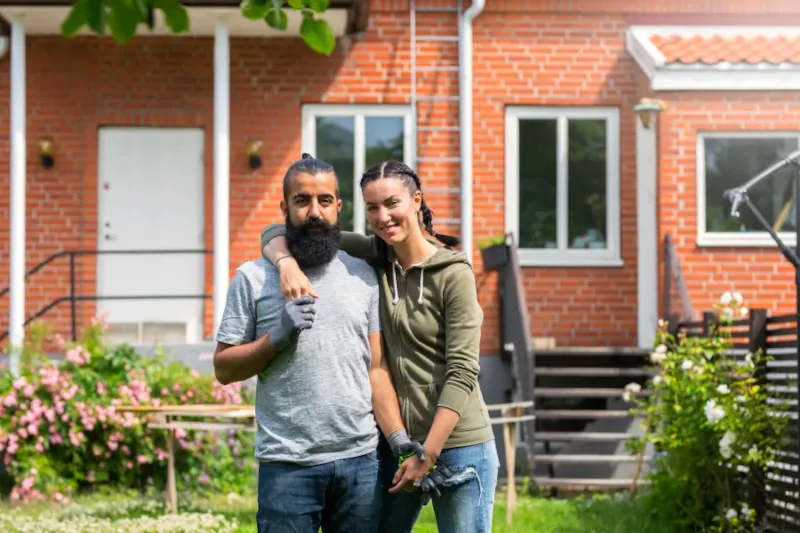 Couple enjoying gardening in front of their home.