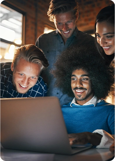 Group of friends collaborating on a laptop