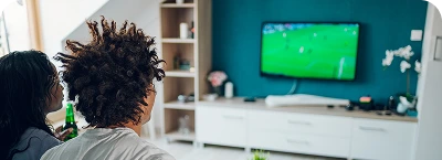 Watching a soccer game on television.