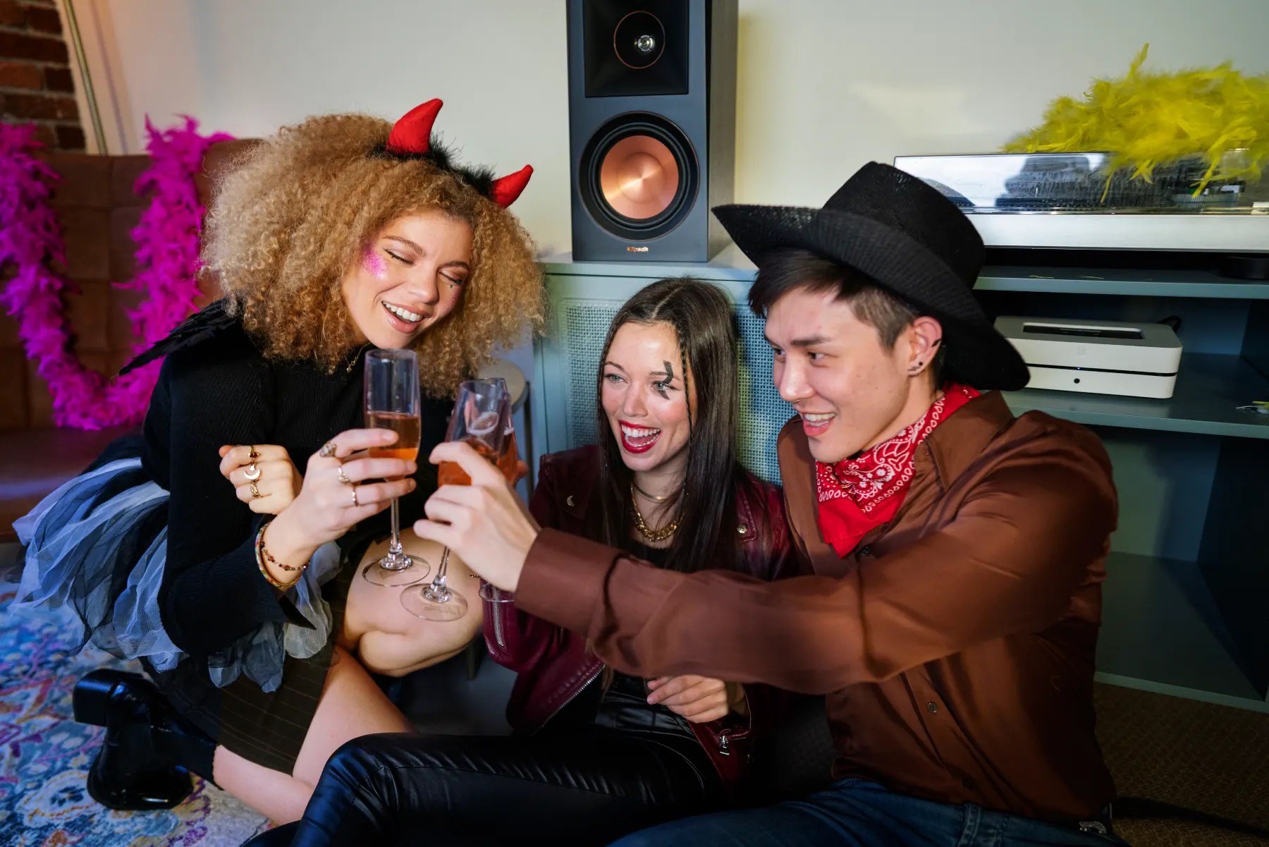 Friends celebrating with drinks in festive costumes.